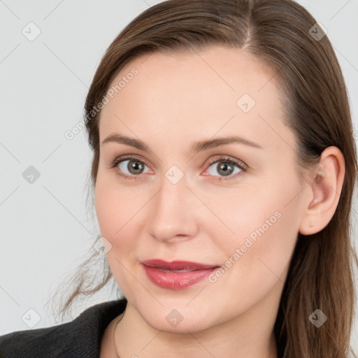 Joyful white young-adult female with long  brown hair and grey eyes