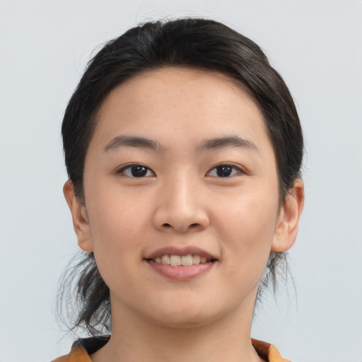 Joyful asian young-adult female with medium  brown hair and brown eyes
