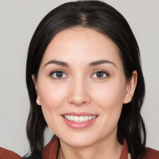 Joyful white young-adult female with long  black hair and brown eyes