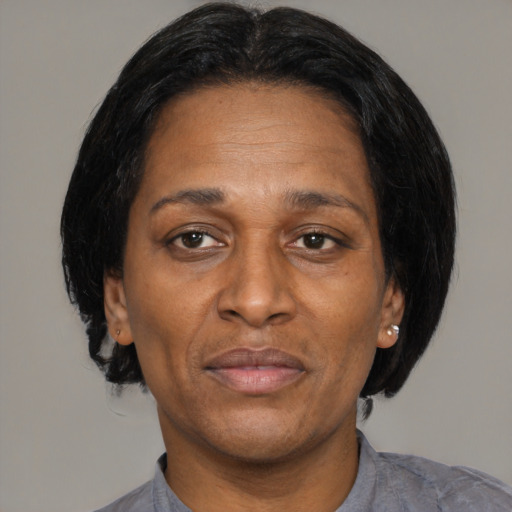 Joyful black adult female with medium  black hair and brown eyes