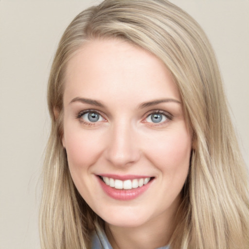 Joyful white young-adult female with long  brown hair and blue eyes