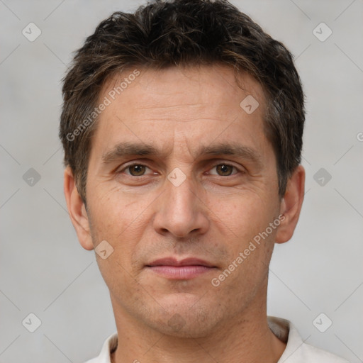 Joyful white adult male with short  brown hair and brown eyes