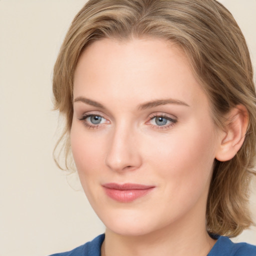 Joyful white young-adult female with medium  brown hair and blue eyes