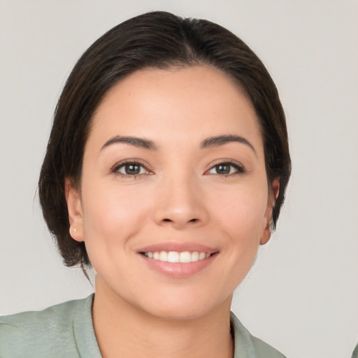 Joyful white young-adult female with medium  brown hair and brown eyes