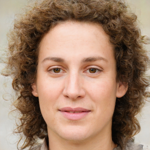 Joyful white young-adult female with medium  brown hair and green eyes