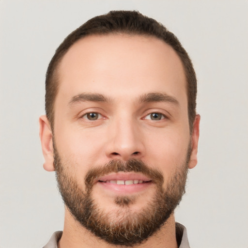 Joyful white young-adult male with short  brown hair and brown eyes