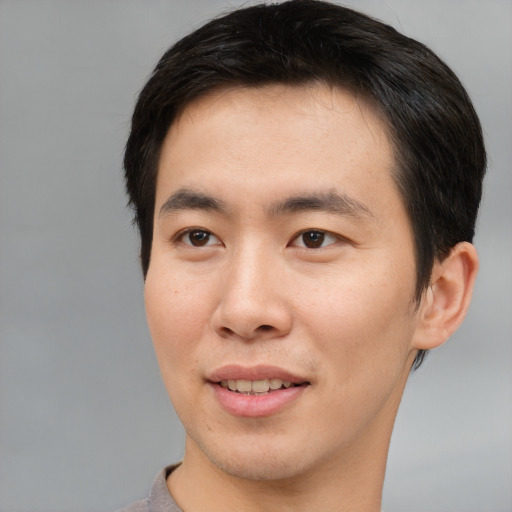 Joyful asian young-adult male with short  brown hair and brown eyes