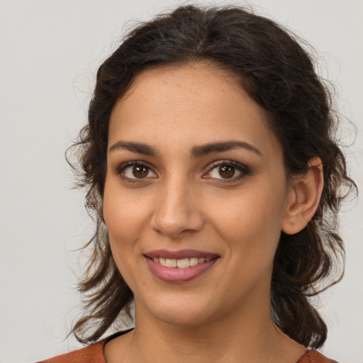 Joyful white young-adult female with medium  brown hair and brown eyes