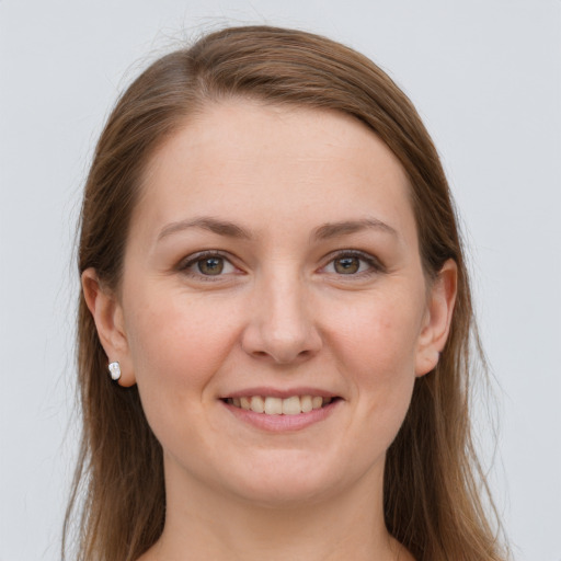 Joyful white young-adult female with long  brown hair and grey eyes