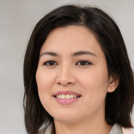 Joyful asian young-adult female with medium  brown hair and brown eyes