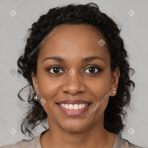 Joyful black young-adult female with medium  brown hair and brown eyes