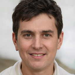 Joyful white young-adult male with short  brown hair and brown eyes