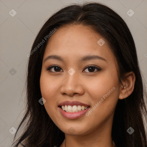 Joyful asian young-adult female with long  brown hair and brown eyes