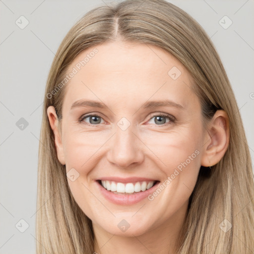 Joyful white young-adult female with long  brown hair and grey eyes