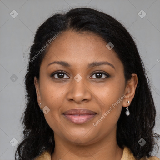 Joyful black adult female with long  brown hair and brown eyes