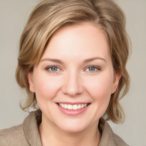 Joyful white young-adult female with medium  brown hair and blue eyes