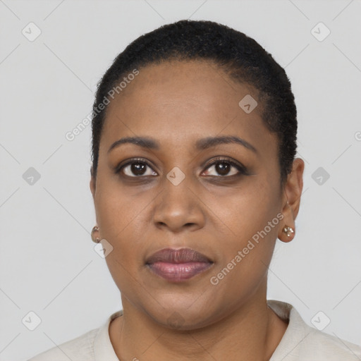 Joyful black young-adult female with short  brown hair and brown eyes