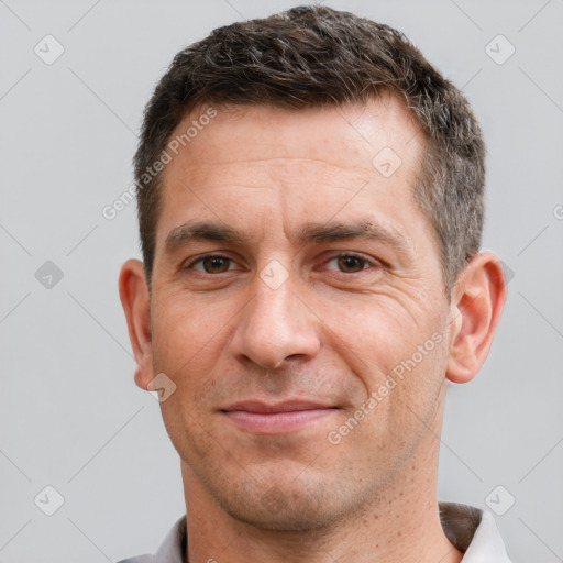 Joyful white adult male with short  brown hair and brown eyes