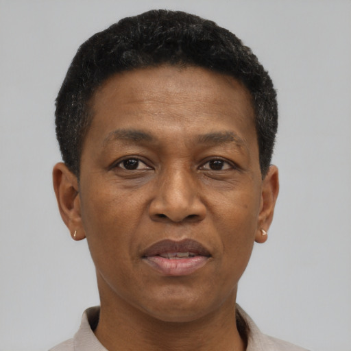 Joyful black adult male with short  brown hair and brown eyes