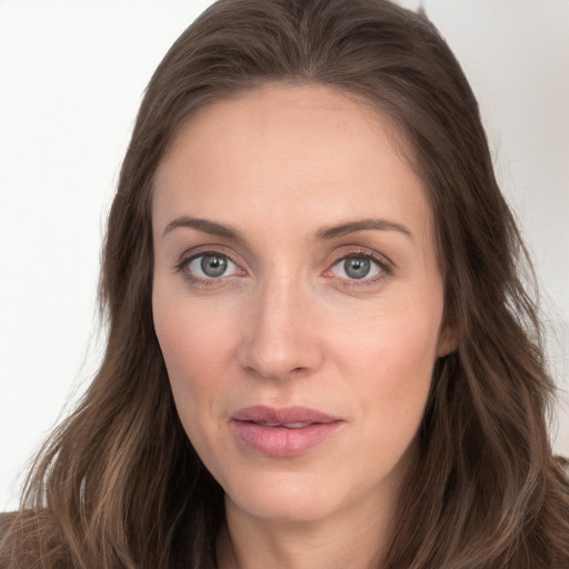 Joyful white young-adult female with long  brown hair and blue eyes