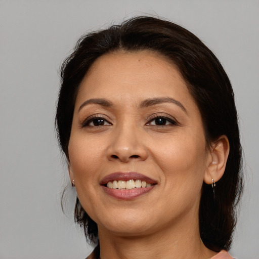 Joyful asian adult female with medium  brown hair and brown eyes