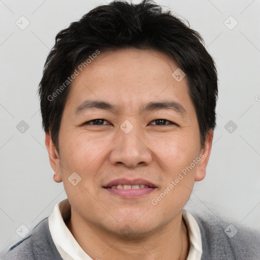 Joyful asian adult male with short  brown hair and brown eyes