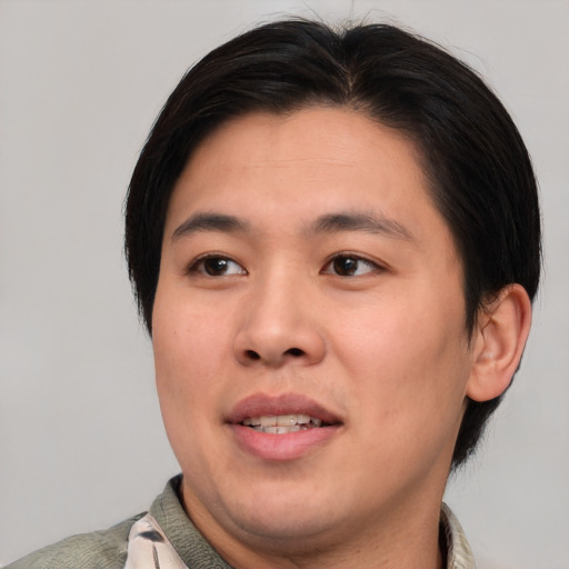 Joyful asian young-adult male with short  brown hair and brown eyes