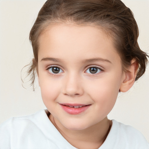 Joyful white child female with short  brown hair and brown eyes