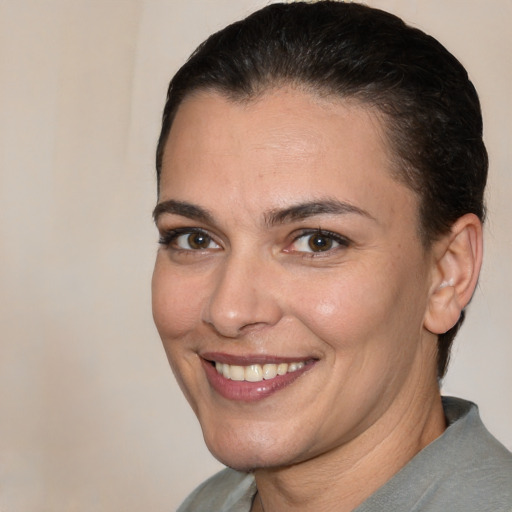 Joyful white adult female with short  brown hair and brown eyes