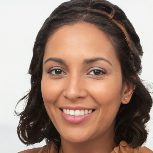 Joyful latino young-adult female with long  brown hair and brown eyes