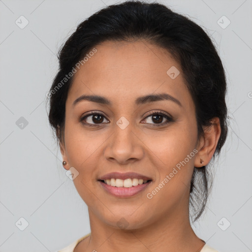 Joyful latino young-adult female with medium  brown hair and brown eyes