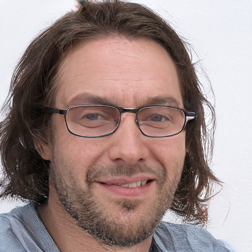 Joyful white adult male with short  brown hair and blue eyes