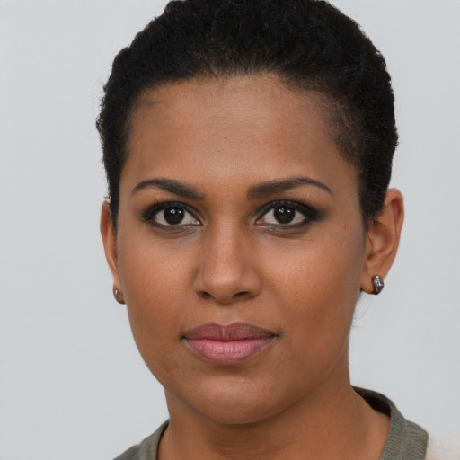 Joyful black young-adult female with short  brown hair and brown eyes