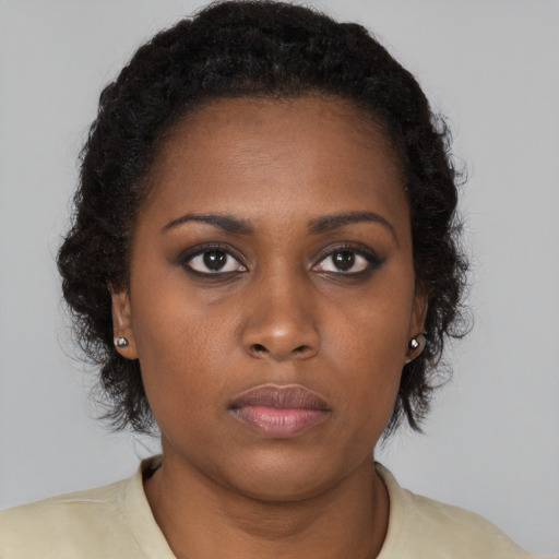 Neutral black young-adult female with medium  brown hair and brown eyes