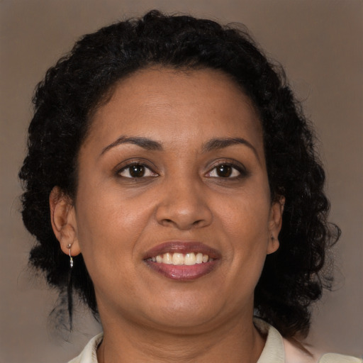 Joyful black adult female with medium  brown hair and brown eyes