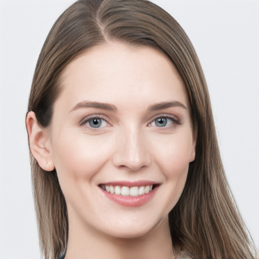 Joyful white young-adult female with long  brown hair and grey eyes