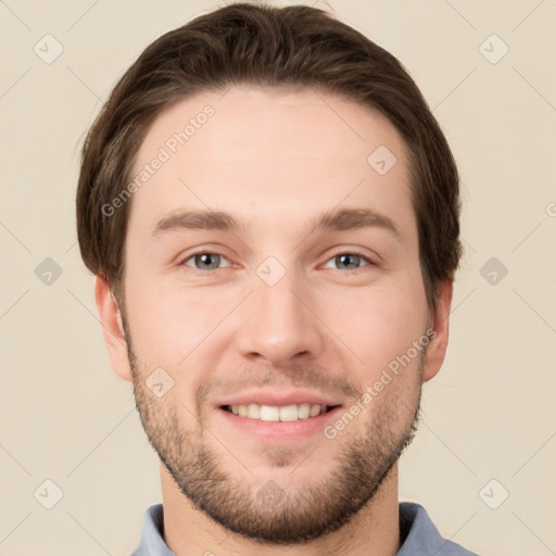 Joyful white young-adult male with short  brown hair and grey eyes