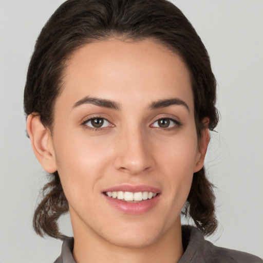 Joyful white young-adult female with medium  brown hair and brown eyes