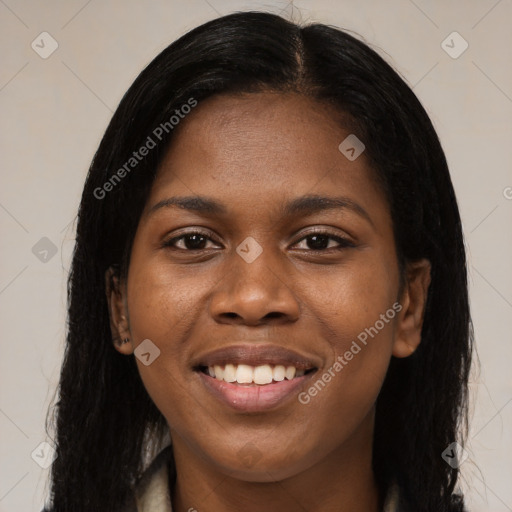 Joyful black young-adult female with long  black hair and brown eyes