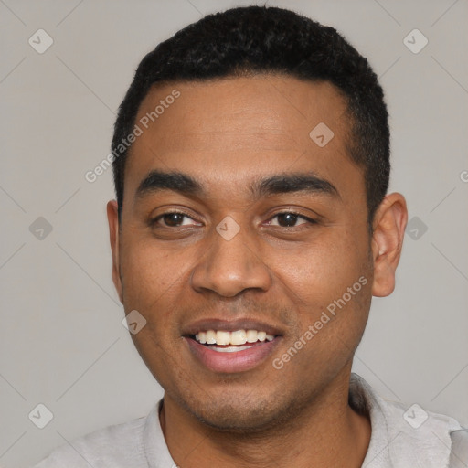 Joyful black young-adult male with short  black hair and brown eyes