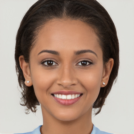 Joyful latino young-adult female with long  brown hair and brown eyes