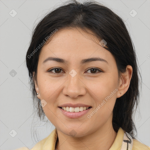 Joyful latino young-adult female with medium  brown hair and brown eyes