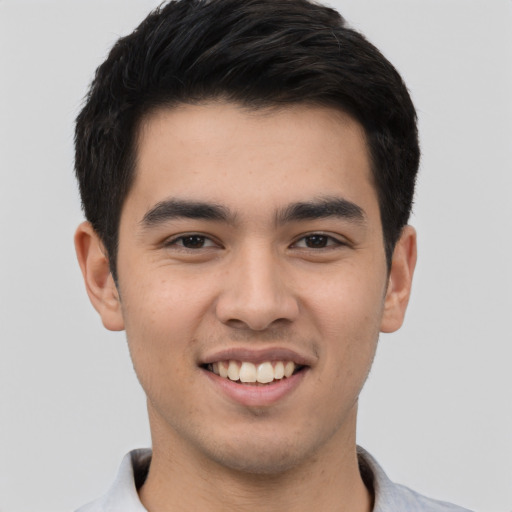 Joyful asian young-adult male with short  black hair and brown eyes