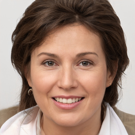 Joyful white adult female with medium  brown hair and brown eyes