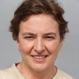 Joyful white adult female with medium  brown hair and blue eyes