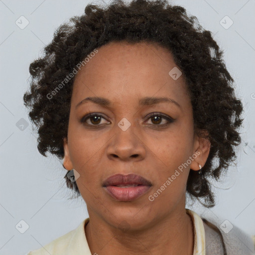 Joyful black adult female with short  brown hair and brown eyes