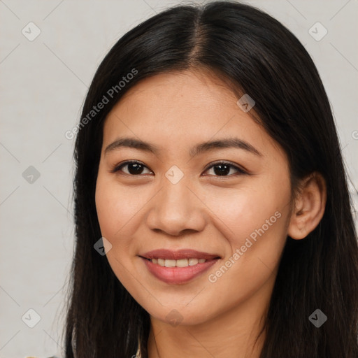 Joyful latino young-adult female with long  brown hair and brown eyes