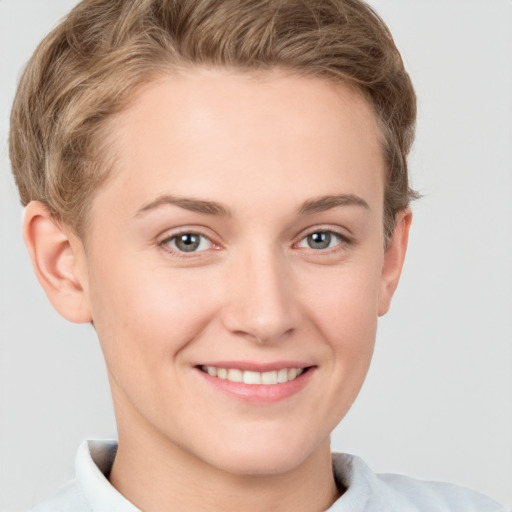 Joyful white young-adult female with short  brown hair and grey eyes