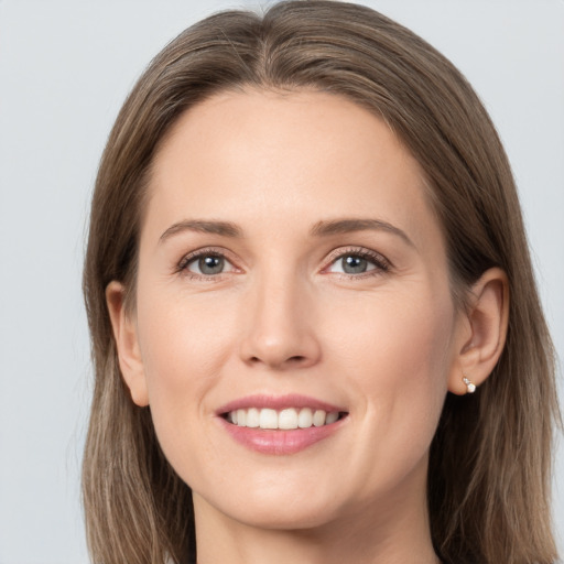 Joyful white young-adult female with long  brown hair and grey eyes