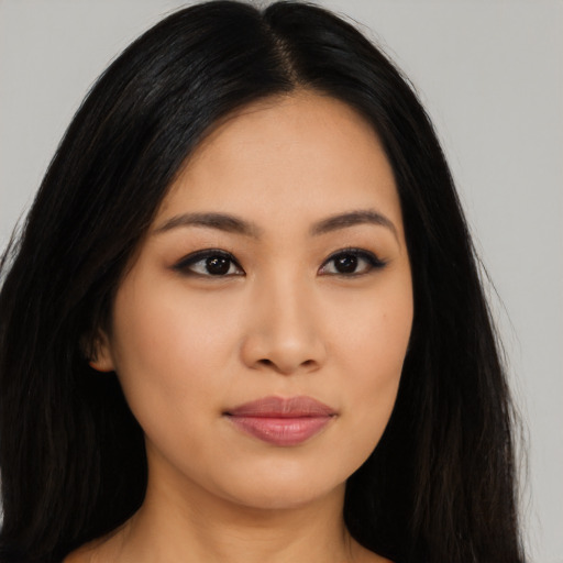 Joyful latino young-adult female with long  black hair and brown eyes